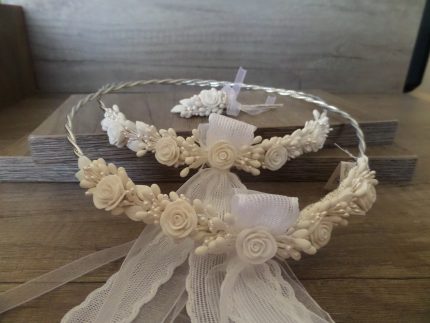 White floral headband with ribbon lace on a wooden surface