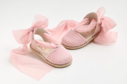 Pink baby espadrille sandals with large pink tulle bows and woven sole on white background.