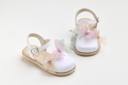 White baby sandals with pastel butterfly decorations on the toes, placed on a white background.