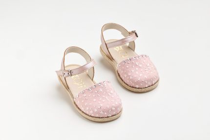 Pink kids' sandals with beaded toe, strappy ankle straps, and espadrille-style sole on a white background.