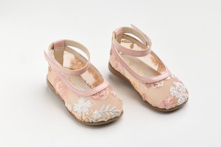Two pink floral children's Mary Jane shoes with ankle straps on a white background