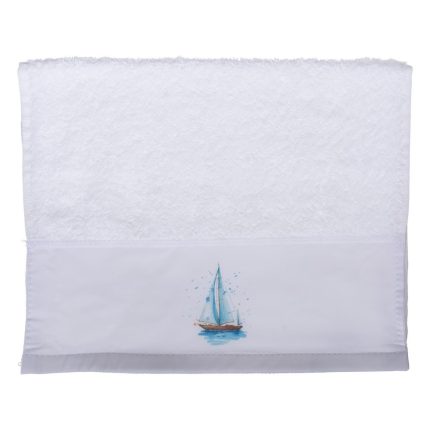 White towel with a small blue sailboat graphic along the bottom band near the hem on a white background.