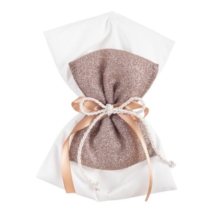 White gift bag wrapped in a glittery rose-gold fabric, tied with cream rope and peach satin ribbons.