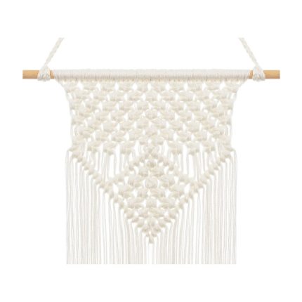White macrame wall hanging with a knotted diamond pattern and long fringe from a wooden rod used as wall decor.