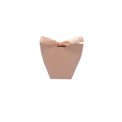 Pastel pink gift box with a pale pink satin ribbon tied in a bow on top against a white background.