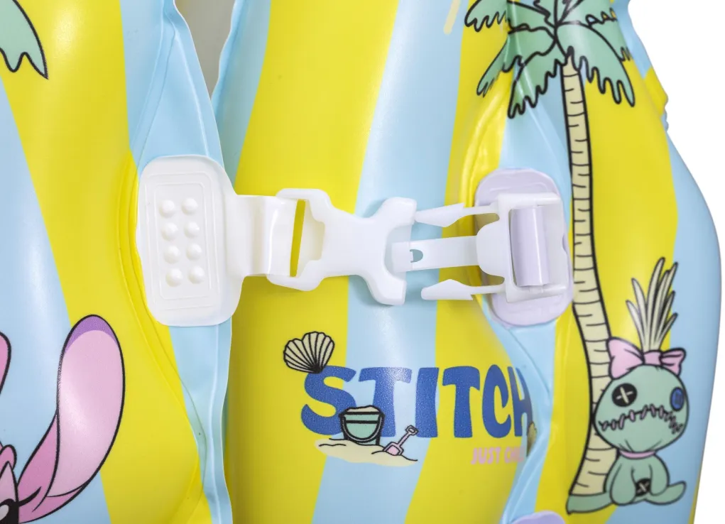 401312009104_3 Close-up of a white plastic buckle on a yellow-and-blue inflatable pool float with tropical print and cartoon characters, showing the fastening mechanism.