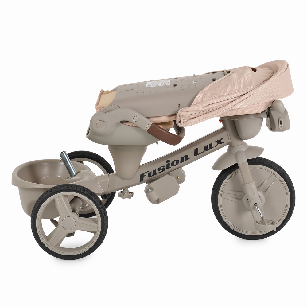 7462827-1000x1000 Beige Fusion Lux three-wheeled toddler ride-on toy with a folded fabric canopy over the seat area.