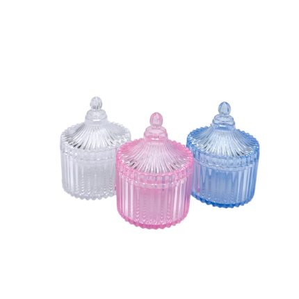 Three decorative ribbed glass jars with knob lids in clear, pink, and blue colors.