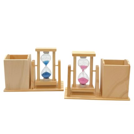 Two wooden desk organizers flanking a pair of glass hourglasses with blue sand on the left and pink sand on the right. All on a light wooden base with small side cubbies on each end.