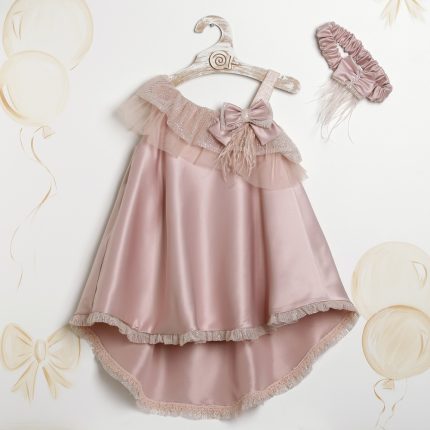 Pink satin dress for a young girl with a ruffled tulle overlay, bow detail, and matching headband on a hanger.
