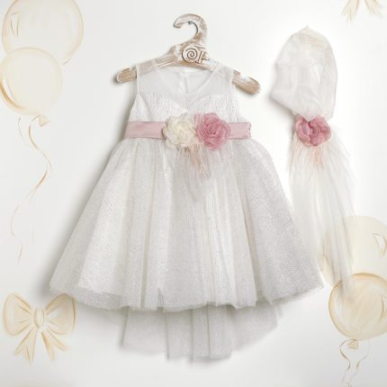 White glittery sleeveless girl’s dress on a hanger with a pink sash and fabric flower; matching sheer veil with a pink flower nearby.