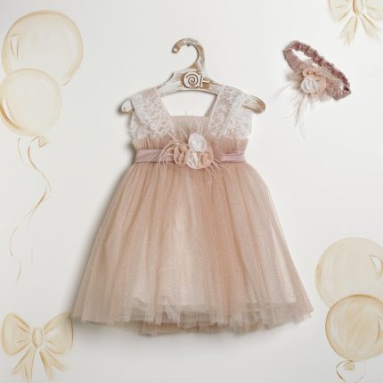 Blush pink lace-and-tulle dress on a hanger with a satin belt and fabric flower; matching headband nearby.