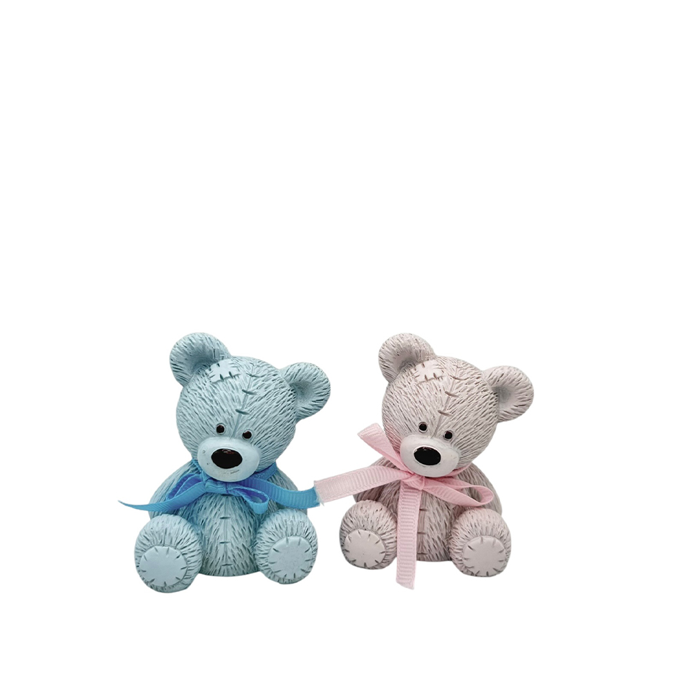 0412A965-1428-F34D-DD4B-019CE2665E4D_21 | La Vie en Rose Two plush teddy bears, blue and pink, sit side by side with matching ribbons tied around their necks (stitch‑style texture).