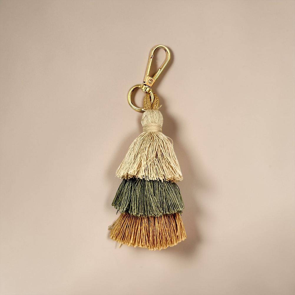 10BF9432-B43E-60FE-93CE-019D055E5621_11 | La Vie en Rose Gold lobster-clasp keychain with three layered tassels in cream, green, and brown hues