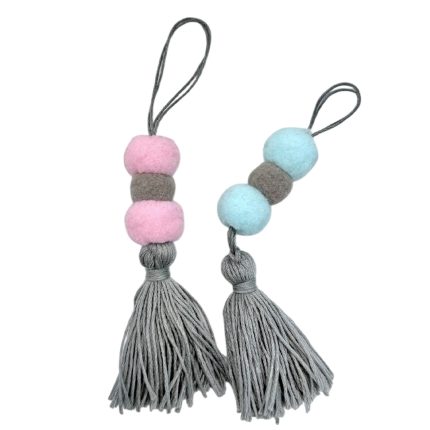 Decorative gray tassel keychain with pastel pink and gray beads on one side and blue and gray beads on the other, hanging loop at top.
