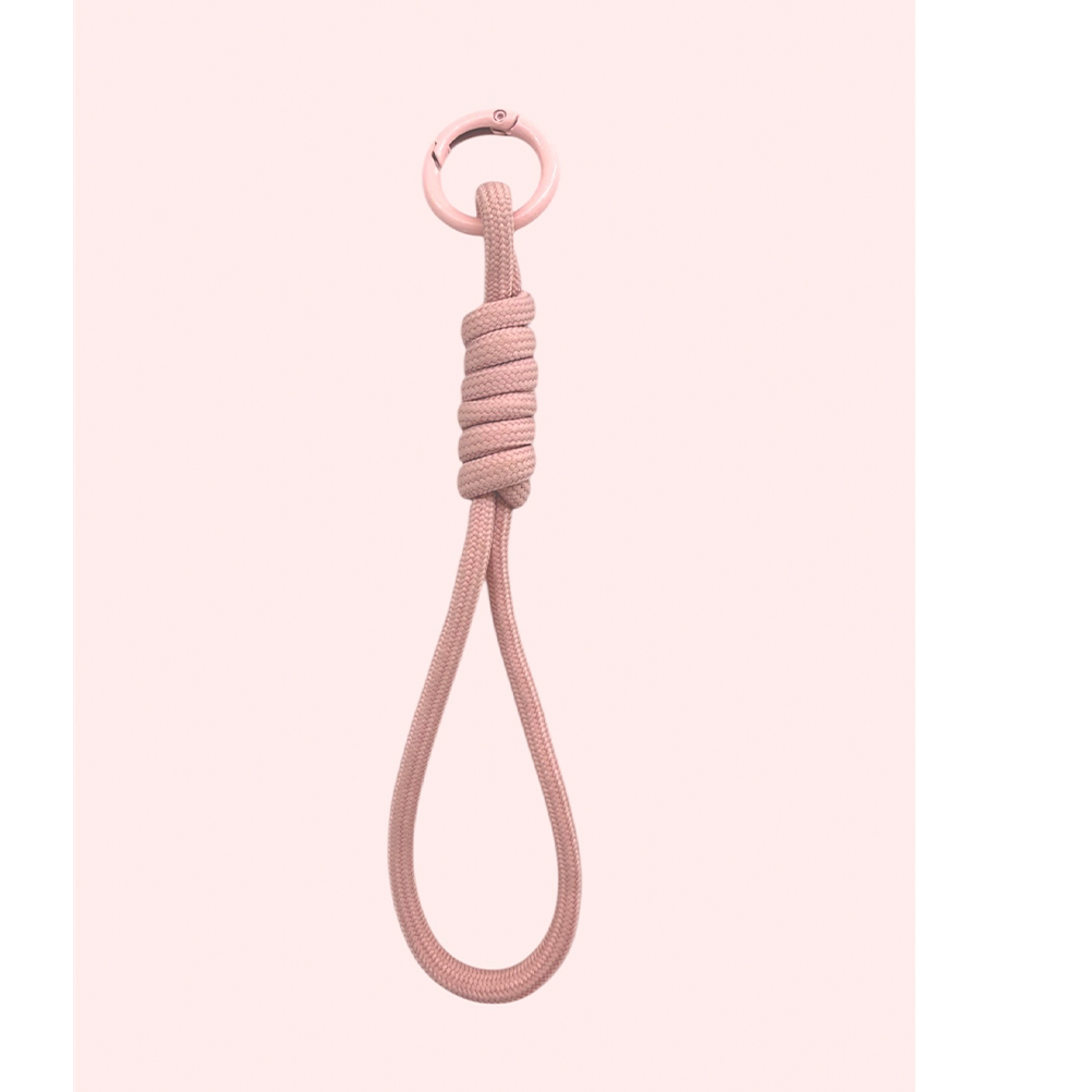 1B16885C-88BB-2561-E53B-019D29D60AAE_11 | La Vie en Rose Pink rope loop with a metal ring at the top, tied in a knot, hanging against a pale pink background (decorative accessory)