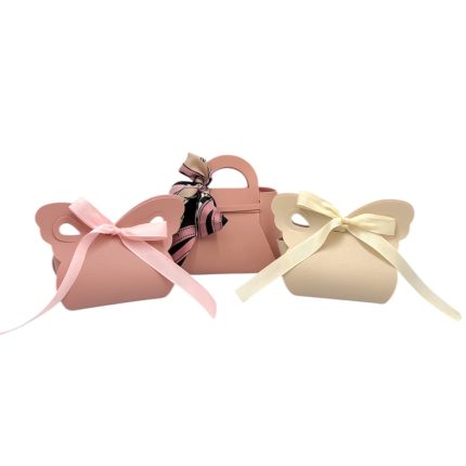 Three pastel handbag-shaped gift boxes with pink and cream ribbons.