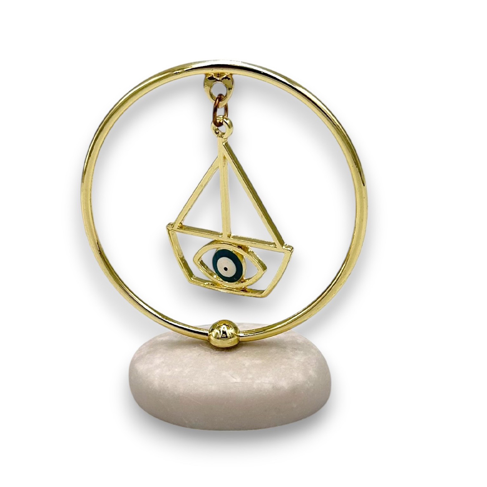 3846FDBE-DCA1-370A-14F8-0196F28F98A9_11 | La Vie en Rose Gold circular pendant with a geometric triangle frame and an eye motif, hanging on a small stand.