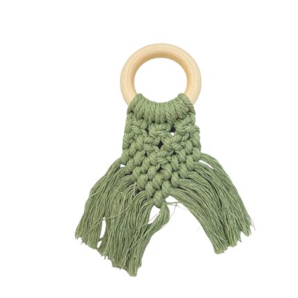 Macrame teething toy with a wooden ring and green fringe tassels
