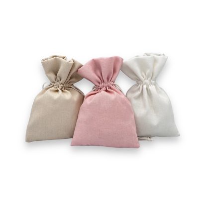Three fabric drawstring bags in beige, pink, and white arranged in a row on a white background.