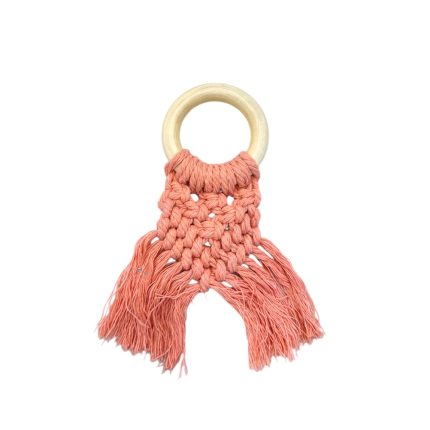 Wooden ring baby teething toy with pink macrame knots and fringed ends.