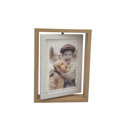 Double-frame photo display: a smiling child holding a fluffy dog, set in a white inner frame within a wooden outer frame.