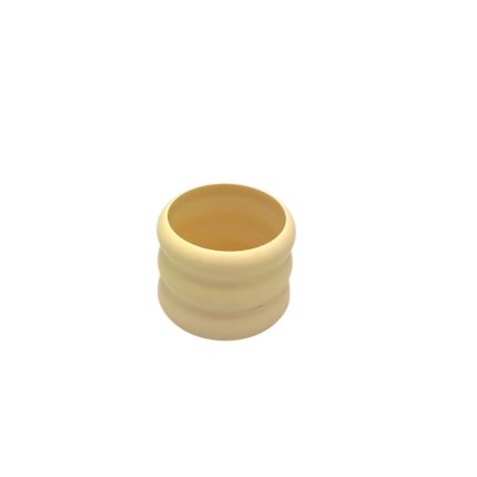 Cream-colored ribbed hollow ring, a small cylindrical silicone gasket-like object.