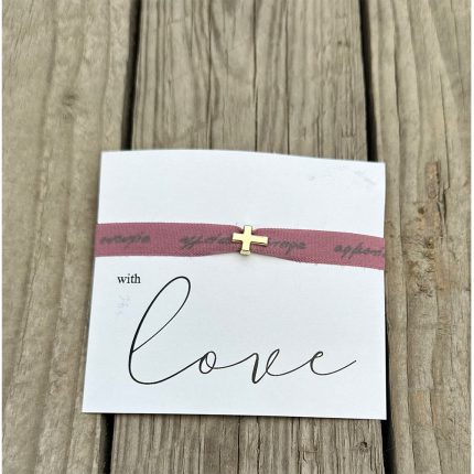 A white card with the word 'love' in script, 'with' printed above, wrapped by a pink ribbon bracelet with a small gold cross charm.