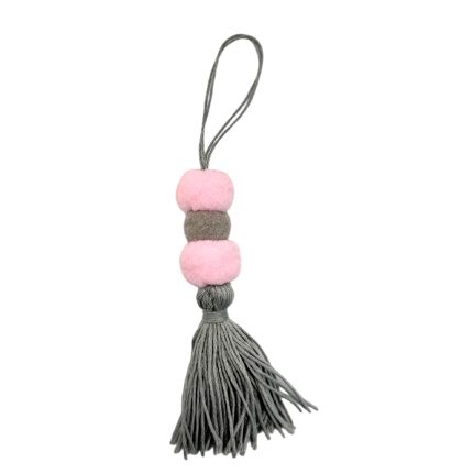 Decorative tassel keychain with pink pom-poms, a gray bead, and a long gray fringe.