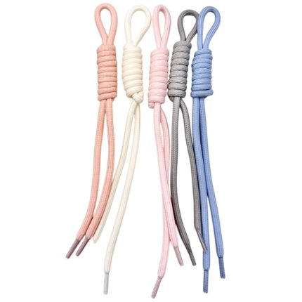 Five pastel shoelaces tied in loops, arranged from peach to blue on a white background.