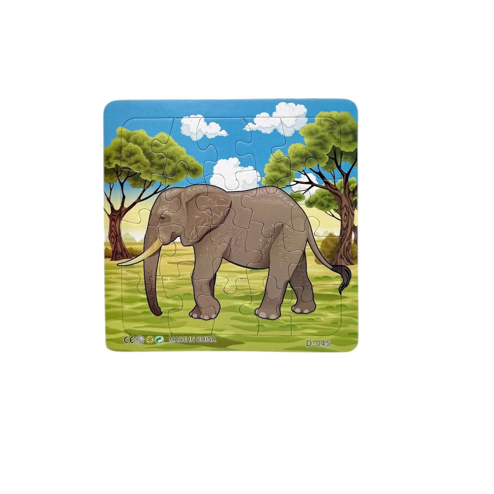 73262138-5303-3394-E60E-019D0B2CCB90_11 | La Vie en Rose A jigsaw puzzle showing a grey elephant walking in a grassy savannah with trees and a blue sky in the background.