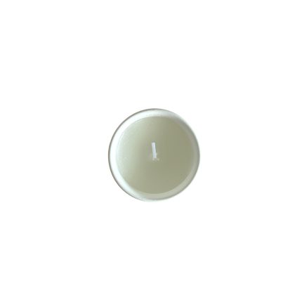 Top view of a small round tealight candle in a metal cup, unlit.