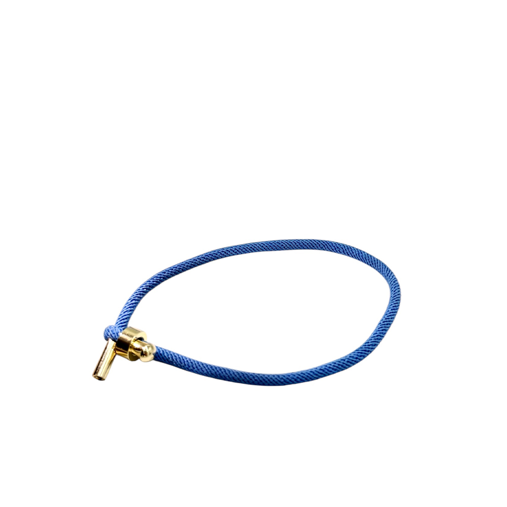 755CAB6F-B97F-19AC-7A53-019D009E8DF1_11 | La Vie en Rose Blue braided cord bracelet with a gold-toned barrel clasp and small bead detail on the end cap.