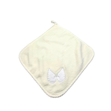 Cream-colored baby bib in a diamond shape with a small white embroidered bow at the corner; soft towel-like fabric and stitched edges.