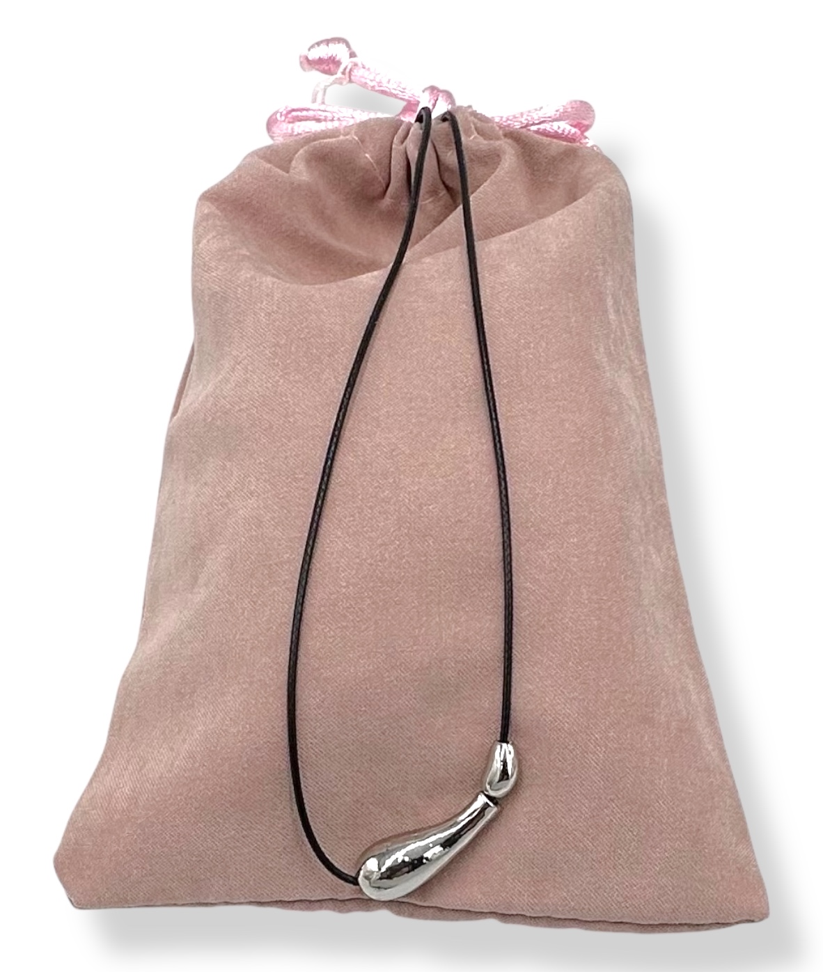98B48F73-8E8C-5D94-D010-019A113B869F_21 | La Vie en Rose Silver curved horn pendant on a black cord necklace, displayed in a soft pink velvet drawstring pouch