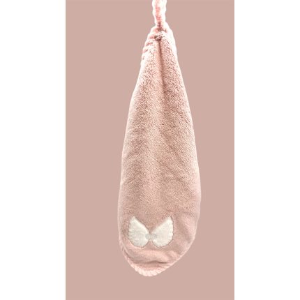 Pink fluffy slipper with a white bow at the toe, shown vertically against a beige background.