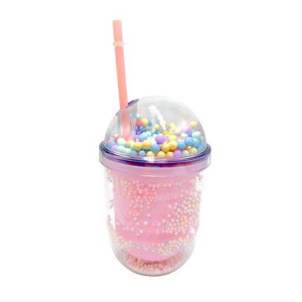 Pink travel cup with a clear dome lid filled with colorful candy beads and a pink straw, resembling a decorative smoothie cup.