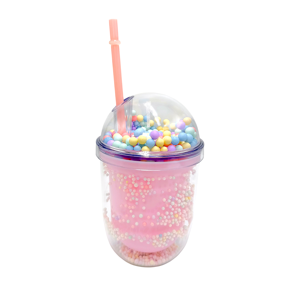 DF64B354-2336-738E-76A5-019E6485D773_11 | La Vie en Rose Pink travel cup with a clear dome lid filled with colorful candy beads and a pink straw, resembling a decorative smoothie cup.