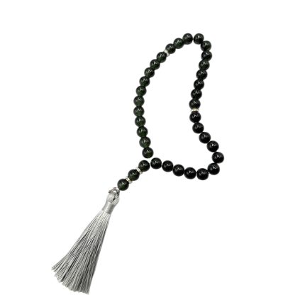 Black bead mala prayer necklace with a silver tassel against a white background