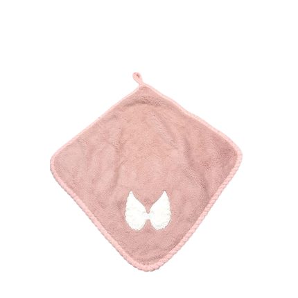 Soft pink baby washcloth in a diamond shape with a white bow applique at the center-right edge.