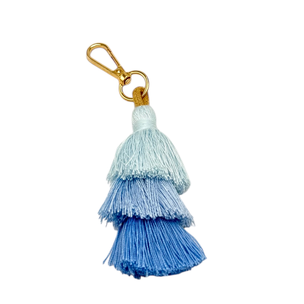 E4092B5E-7FF4-2DBD-B171-019D05A55C0B_11 | La Vie en Rose Gold lobster-clasp keychain with a three-layer blue tassel in light to dark blue hues.