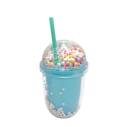 Blue milkshake in a clear cup with a domed lid filled with colorful round sprinkles and a green straw