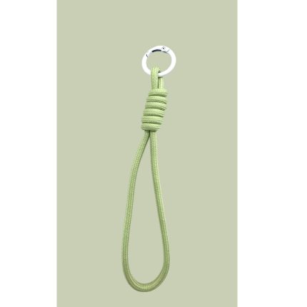 Green rope loop tied with a knot and a white metal ring at the top against a pale green background (lanyard-style cord).