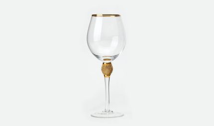 Elegant wine glass with a gold-accented stem on a white background.