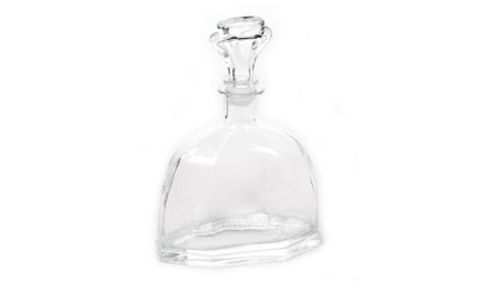 Clear glass decanter with a crystal stopper on a white background