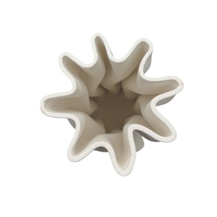 Top view of a white star-shaped ceramic vase with wavy petal-like edges.