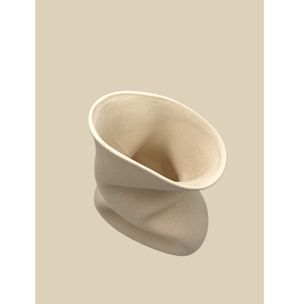 093538DF-0031-8992-9EBC-019D4E67D12A_21 | La Vie en Rose Abstract cream ceramic sculpture with a twisted, funnel-like form set against a beige background, decorative object used for art display