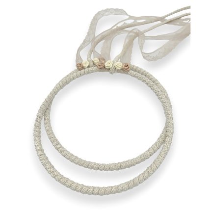 Beige braided headband with cream and blush fabric roses and a lace ribbon.
