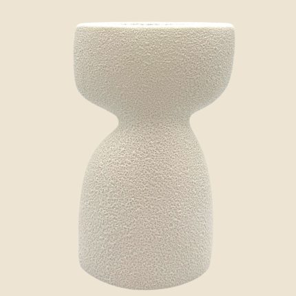 Textured beige ceramic vase with a wide top and narrow waist against a pale background