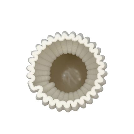 Top-down view of a white, fluted round cupcake liner (muffin cup) with ridged edges and an empty center.